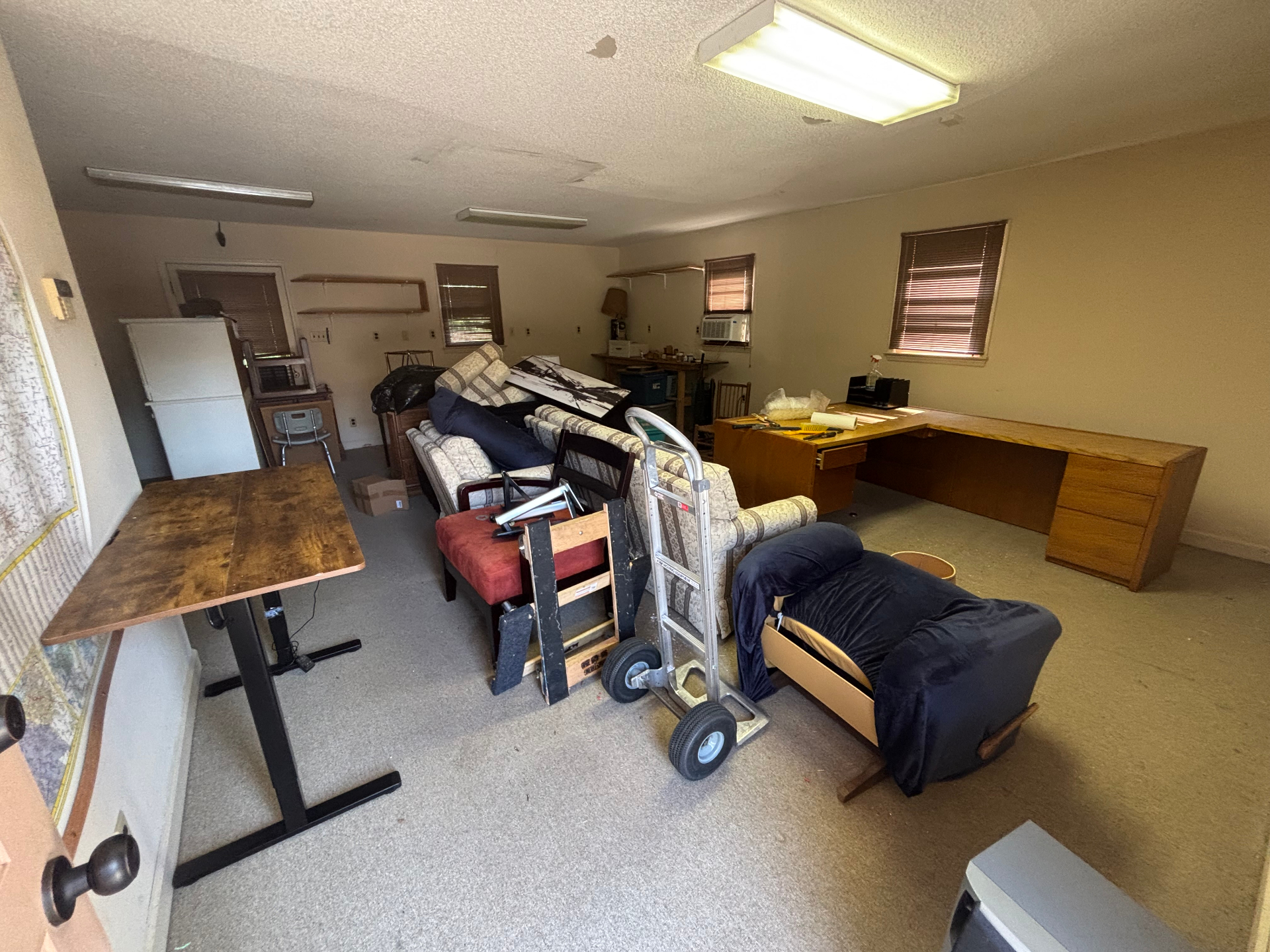 Storage room packed with furniture and debris before junk removal
