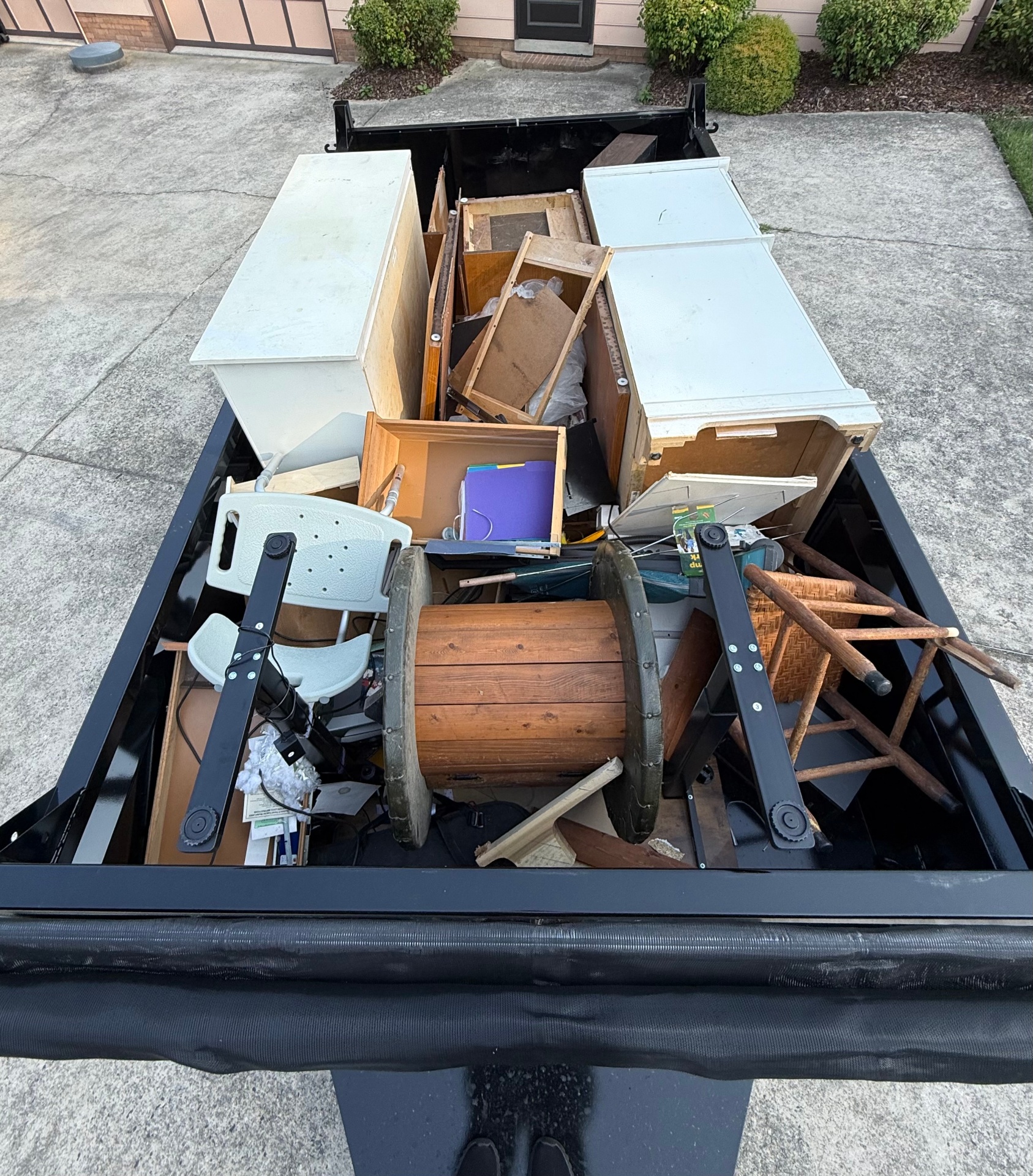 Dump trailer fully loaded with furniture and debris hauled away